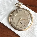 Cyma Gold Filled Open Face Pocket Watch White Arabic Dial Small Seconds 5694007. Fixed Price $290.00.