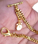 Gold Plated Pocket Watch Chain With T-bar End And Ornate Fob. Fixed Price $16.85.
